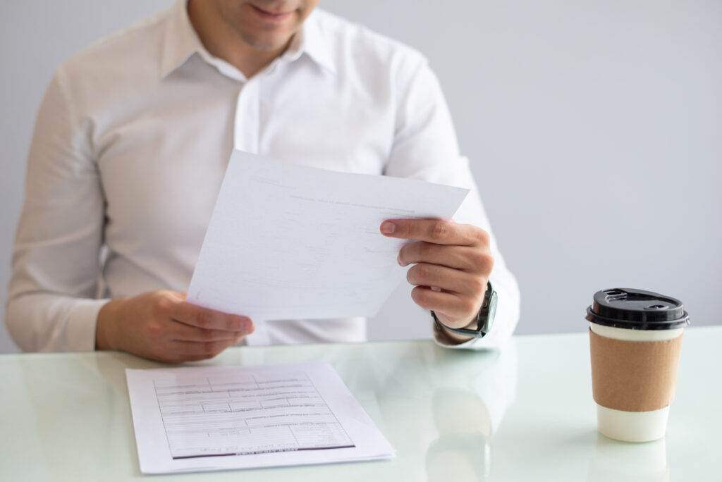 Person reviewing paperwork, possibly related to AFSL exemptions for domestic companies.