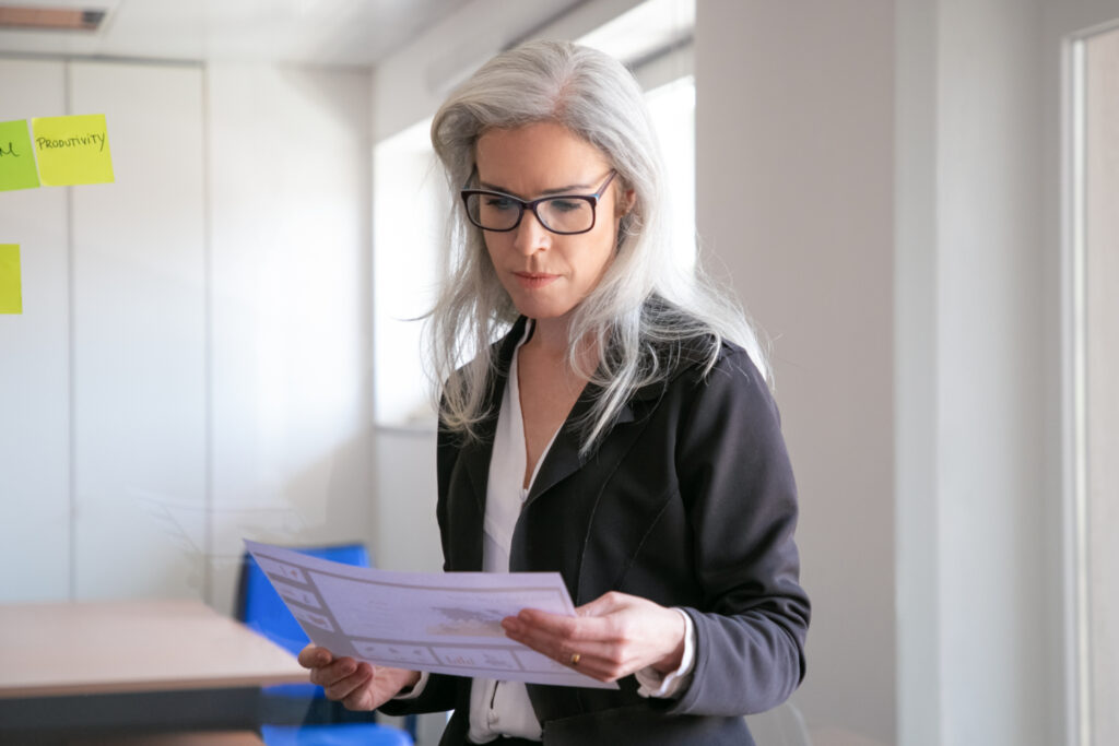 a woman holding a piece of paper
