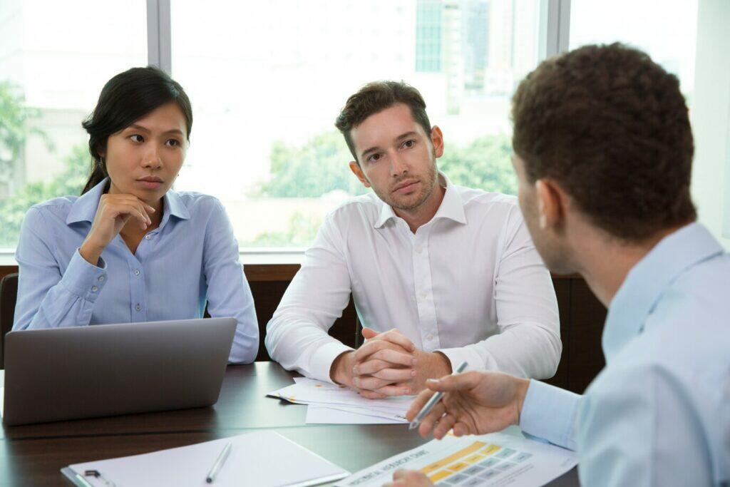 Business professionals discuss superannuation trustee services licensing.