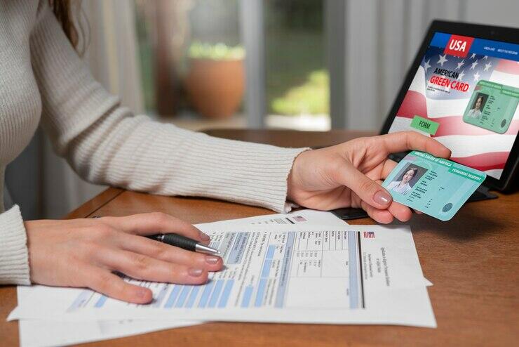Person filling out a green card application.