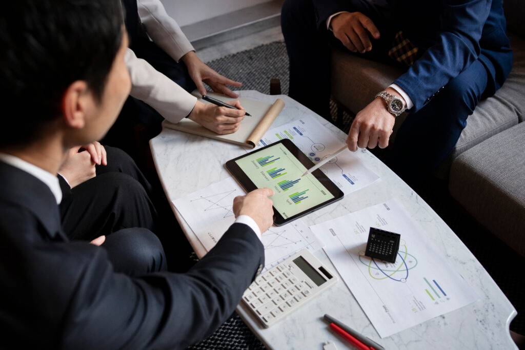 Business team reviewing product disclosure statement requirements on tablet with charts.
