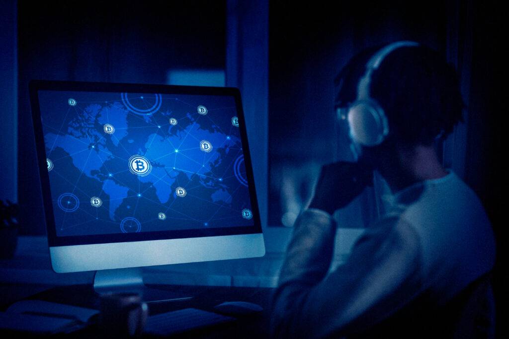 Person analyzing Bitcoin network map on computer, possibly related to DeFi lending/staking in Australia.