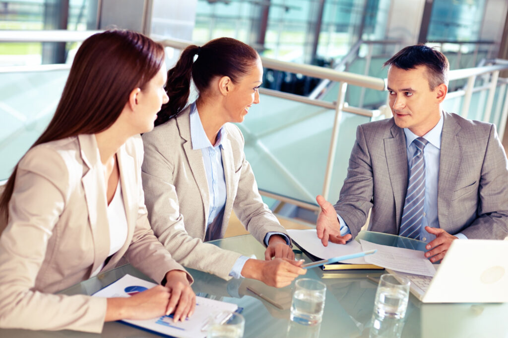 Financial professionals discussing business, highlighting the need for an Australian Financial Services Licence.