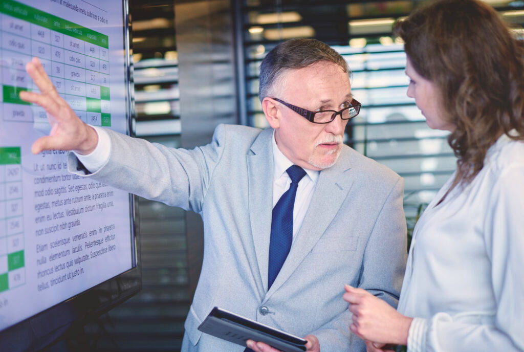 Man points to banking ADI structure on screen, discussing APRA strategy.